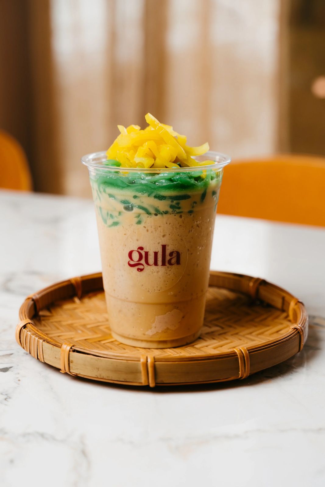 A Gula drink topped with fresh fruit