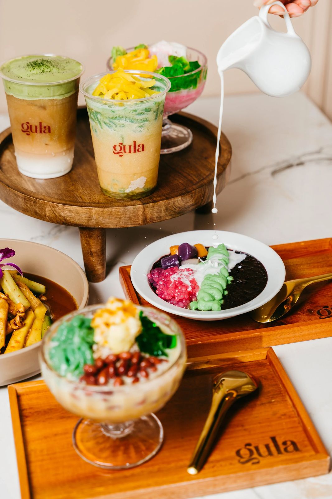 Gula desserts and drinks with a pour of cream