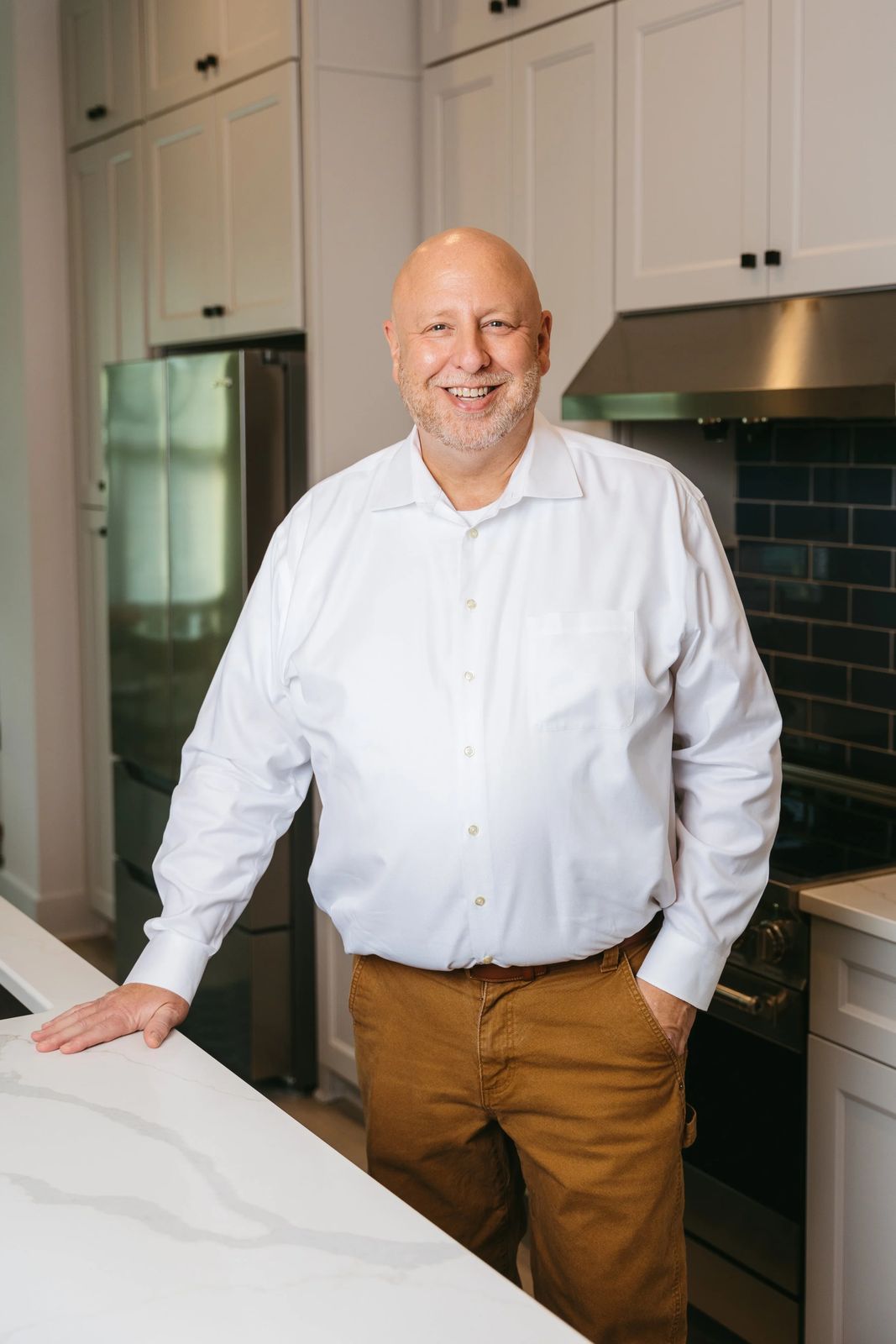 An agent leaning on a kitchen island