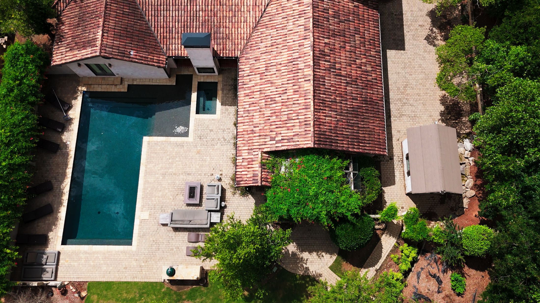 An aerial view of a home with a backyard pool