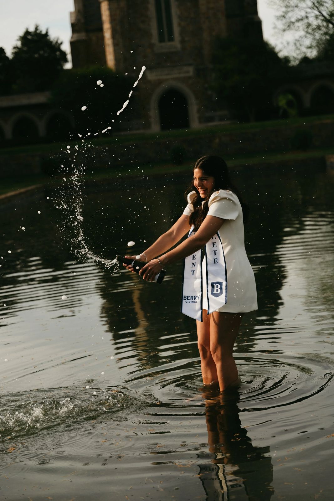 A senior splashing water in a fountain