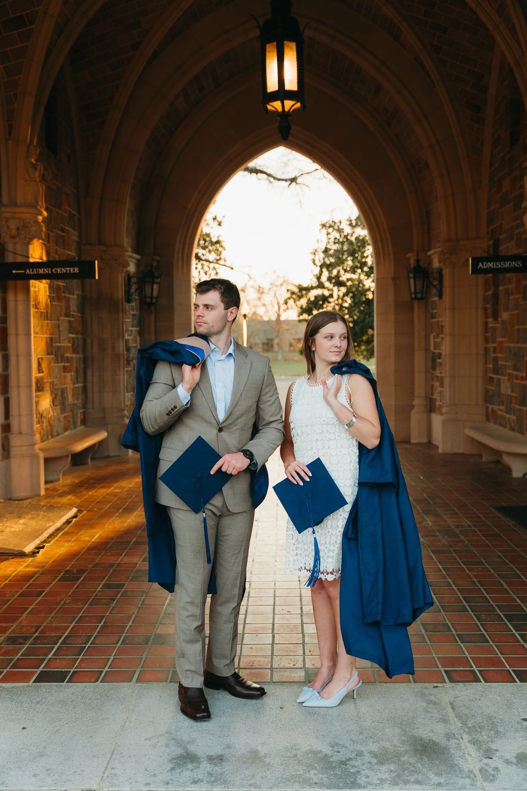 Graduates beneath a lantern-lit archway