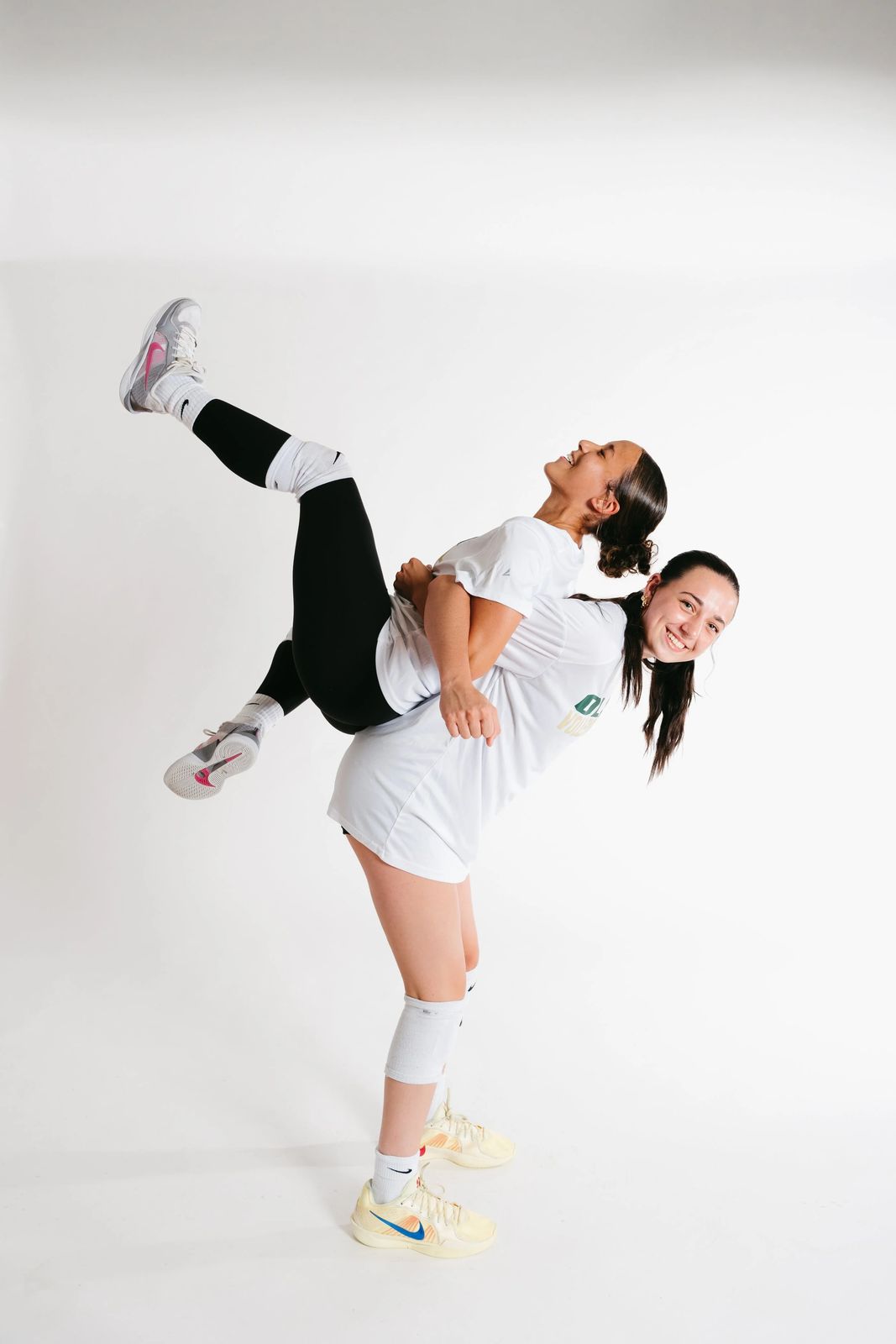 Two athletes in a playful studio pose