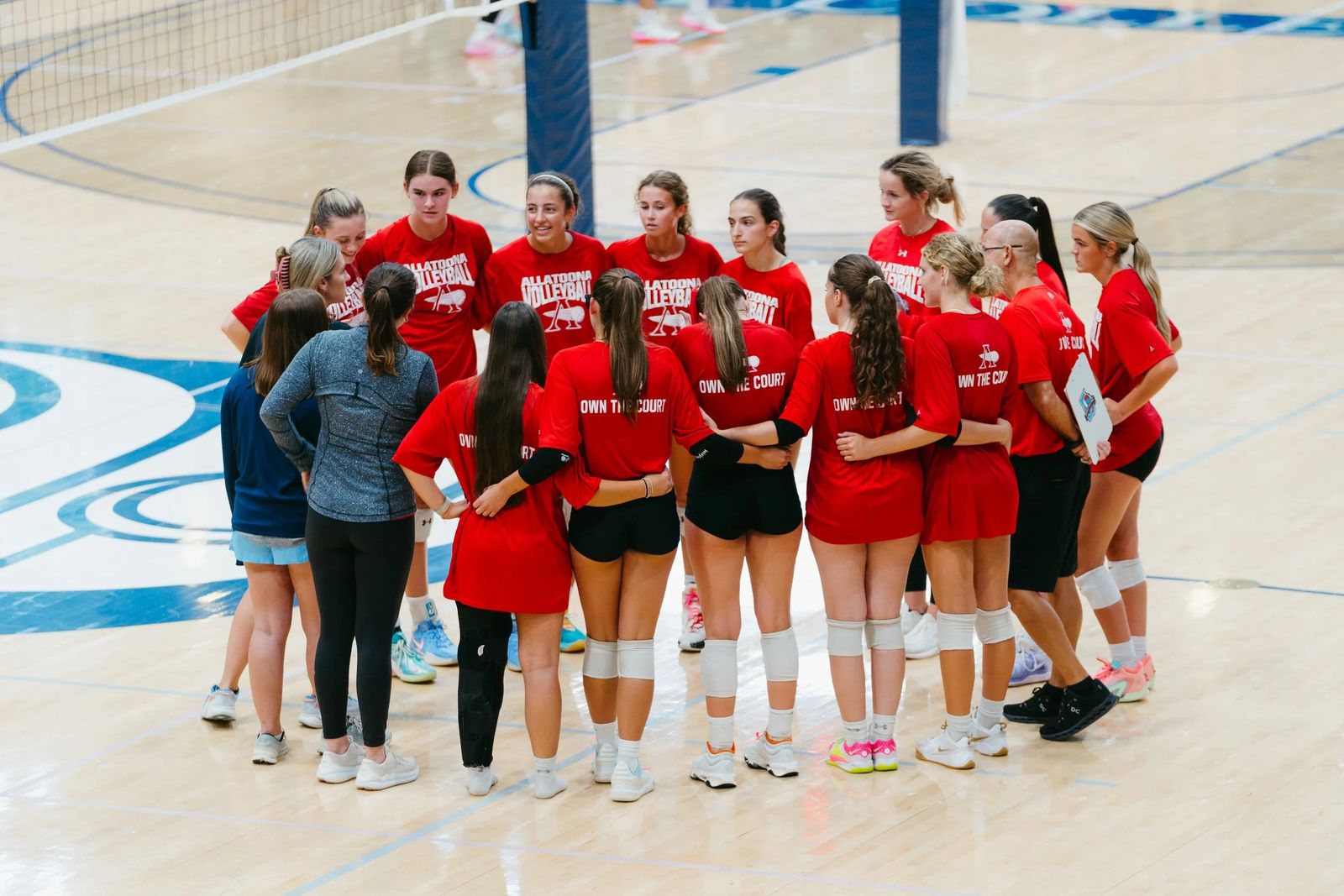 A team huddled together on the court
