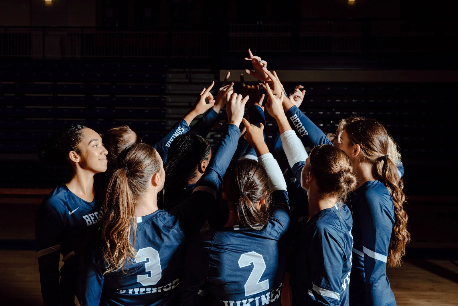 A team huddled around a trophy