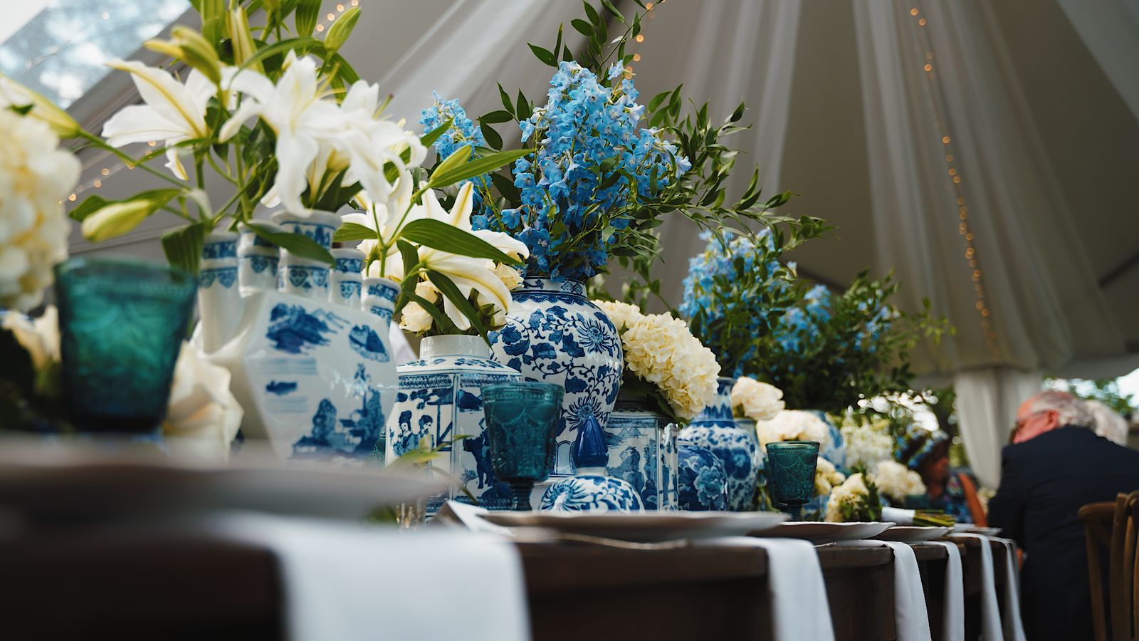 Wedding reception table details under a tent