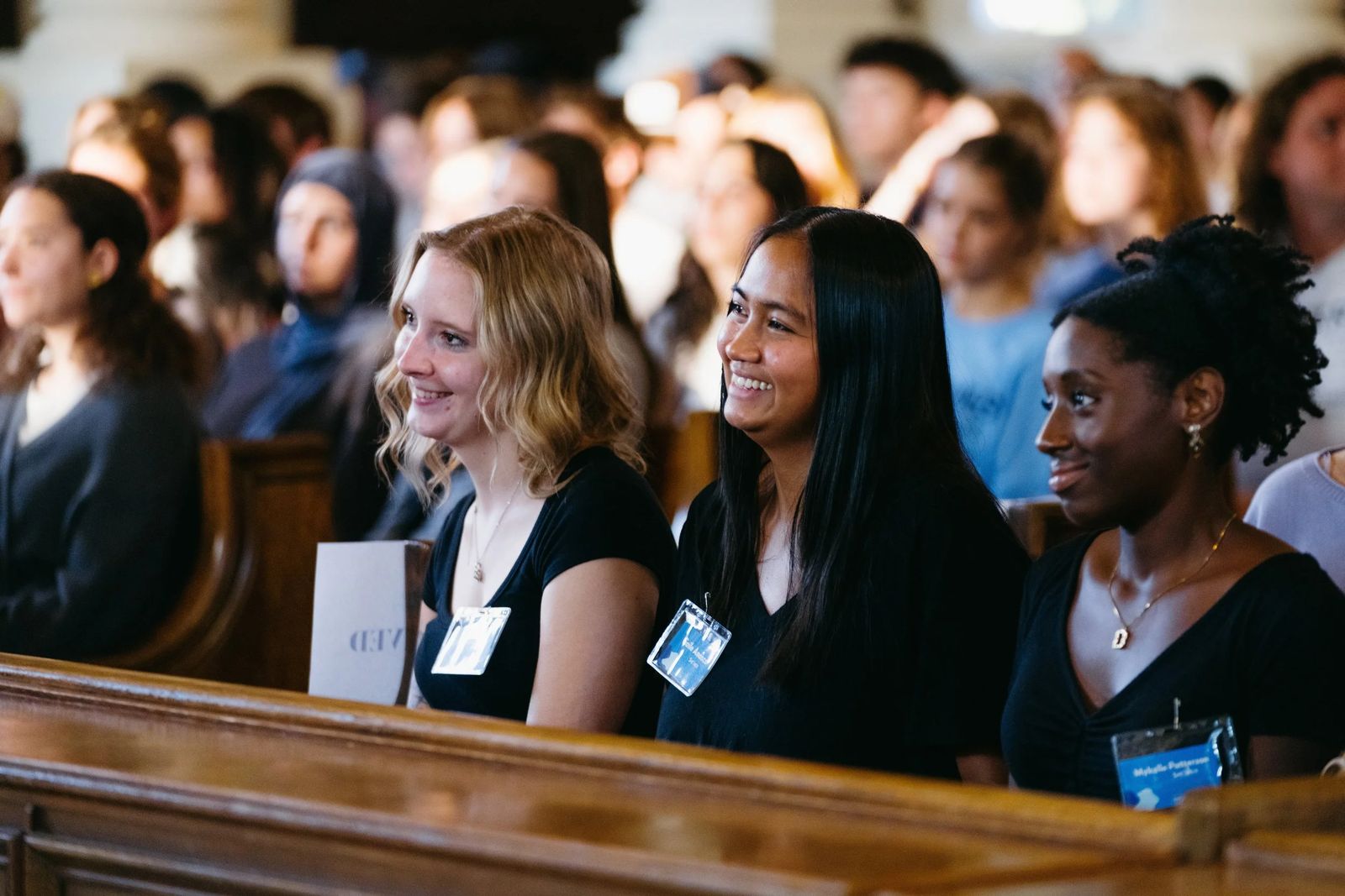 Students seated in a chapel during an event